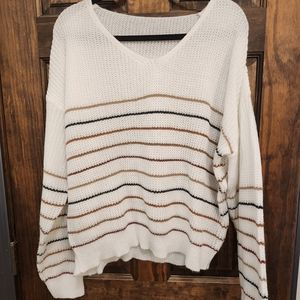 White Sweater with brown and black stripes. Perfect with leggings and boots.